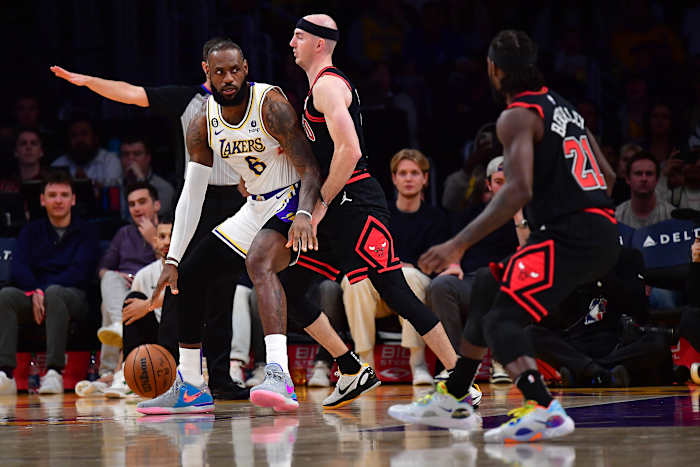 Chicago Bulls guard Alex Caruso defends Los Angeles Lakers forward LeBron James.